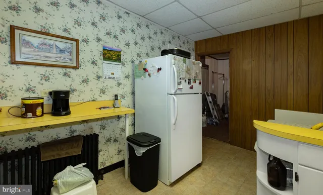 a kitchen with stainless steel appliances granite countertop a sink dishwasher stove and refrigerator with wooden cabinets
