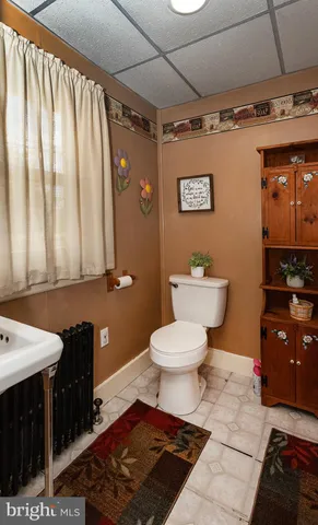 a view of a dining room with furniture and floor to ceiling window