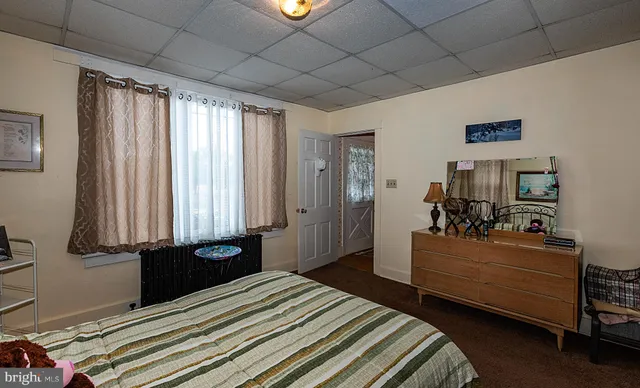 a bathroom with a sink a toilet a mirror and shower