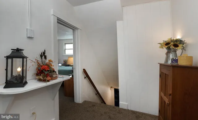 a living room with furniture gym equipment and a chandelier