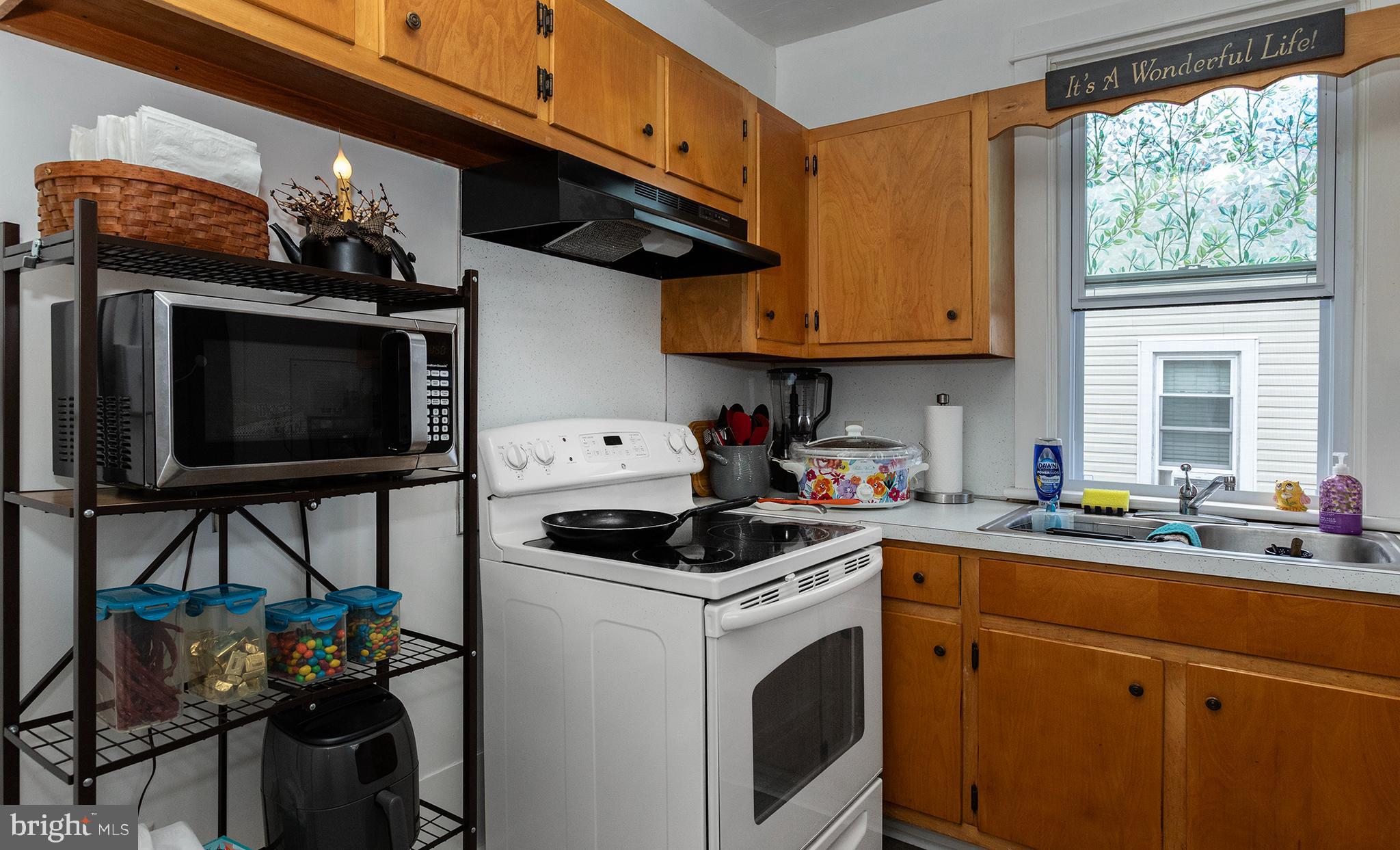 100 West Broad Street Elizabethville, PA 17023 - Photo 53 of 89 a kitchen with stainless steel appliances granite countertop a stove a sink dishwasher and cabinets with wooden floor