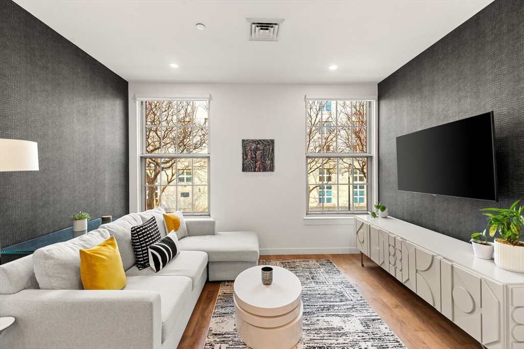 45 1st Avenue, Unit 202 Boston, MA 02129 - Photo 2 of 16 a living room with furniture and a flat screen tv