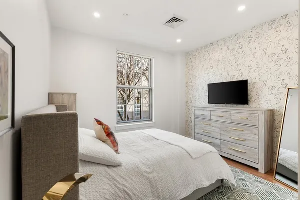 a bedroom with a bed and a flat screen tv