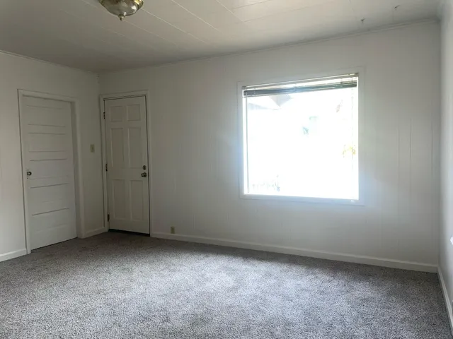 a kitchen with a sink and wooden floor