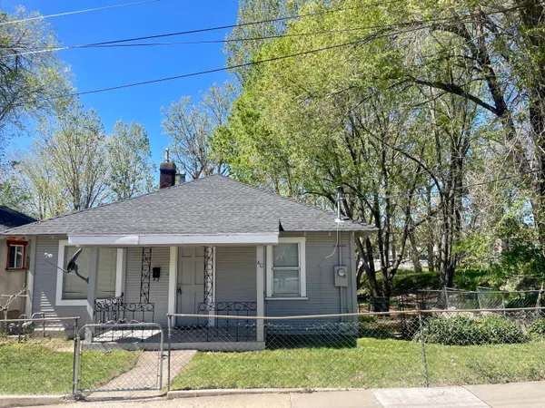 a view of a yard with wooden fence