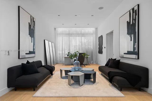 a living room with furniture a rug and a large window
