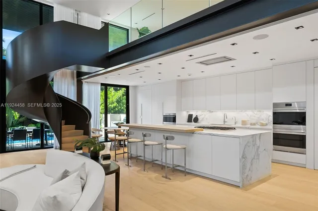 a large white kitchen with a stove and a large window