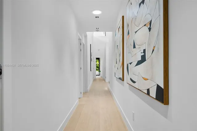 an aerial view of a house with a garden and lake view