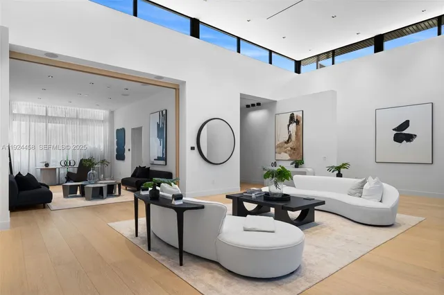 a living room with furniture a rug and a large window