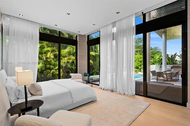 a bedroom with a large bed and a large window