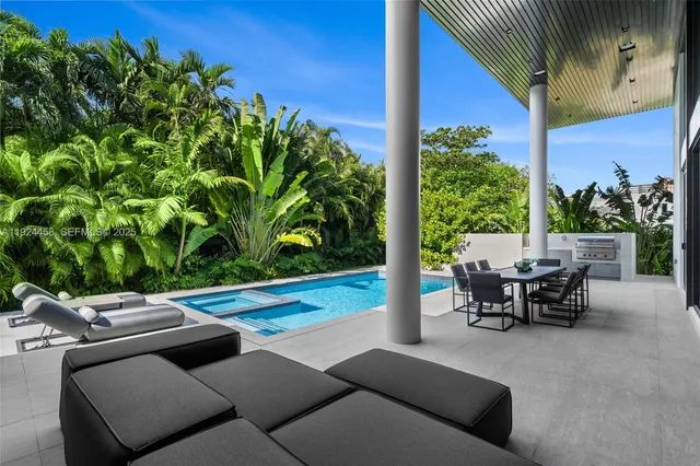 a living room with furniture a table and a large window