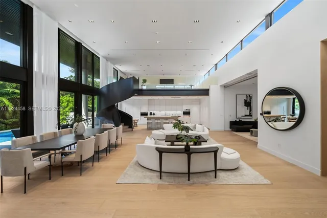 a view of a dining room with furniture and a potted plant