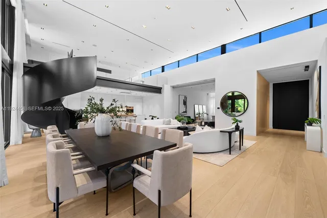 a living room with furniture and large windows