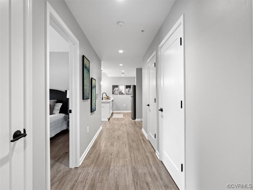 1504 Ewing Park Loop, Unit 207 Midlothian, VA 23113 - Photo 17 of 26 a view of a hallway with wooden floor and closet