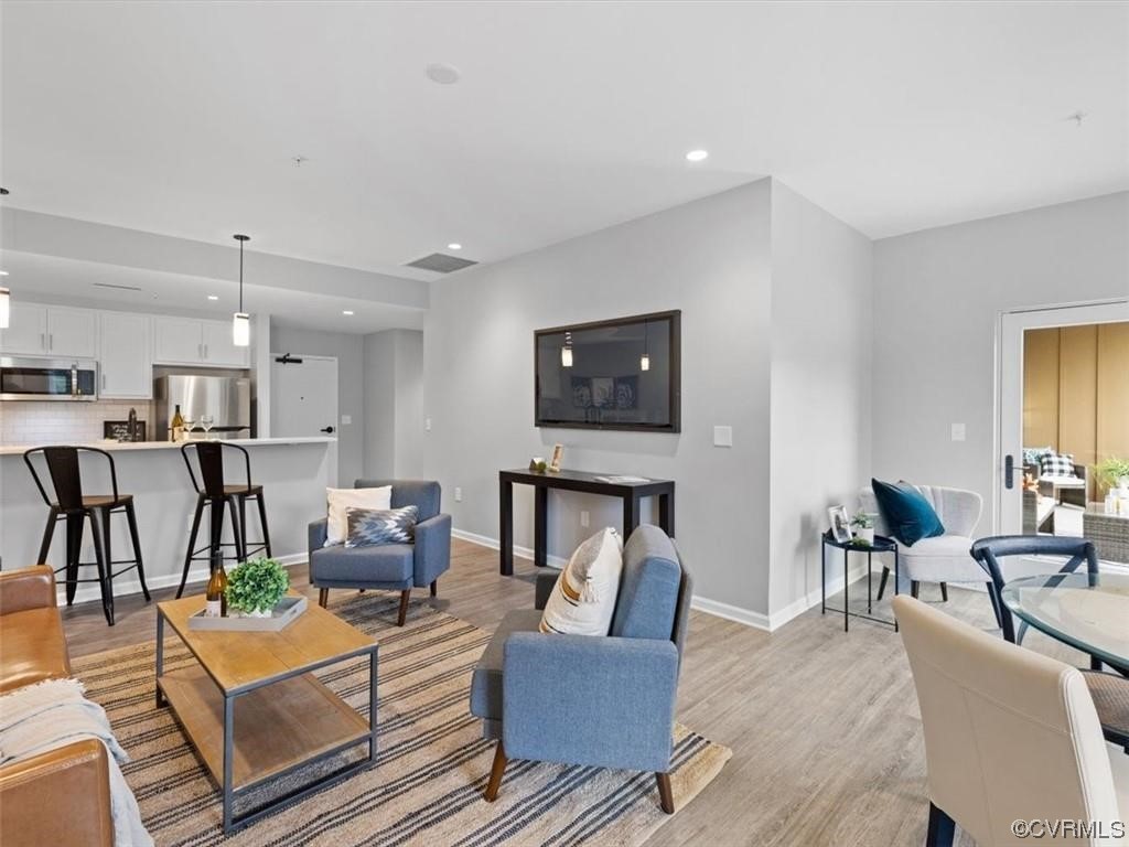 1504 Ewing Park Loop, Unit 207 Midlothian, VA 23113 - Photo 9 of 26 a living room with furniture and a wooden floor