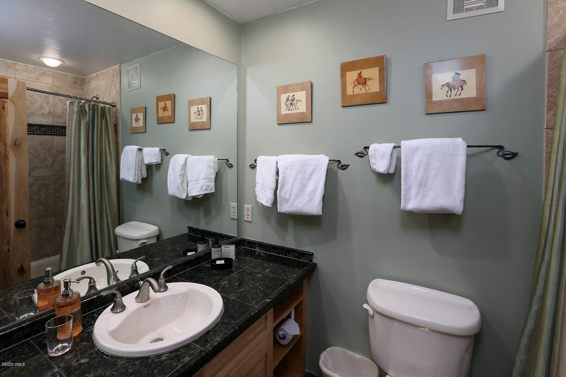 137 Benchmark Road, Unit 520 Avon, CO 81620 - Photo 14 of 22 a bathroom with a granite countertop toilet sink and mirror