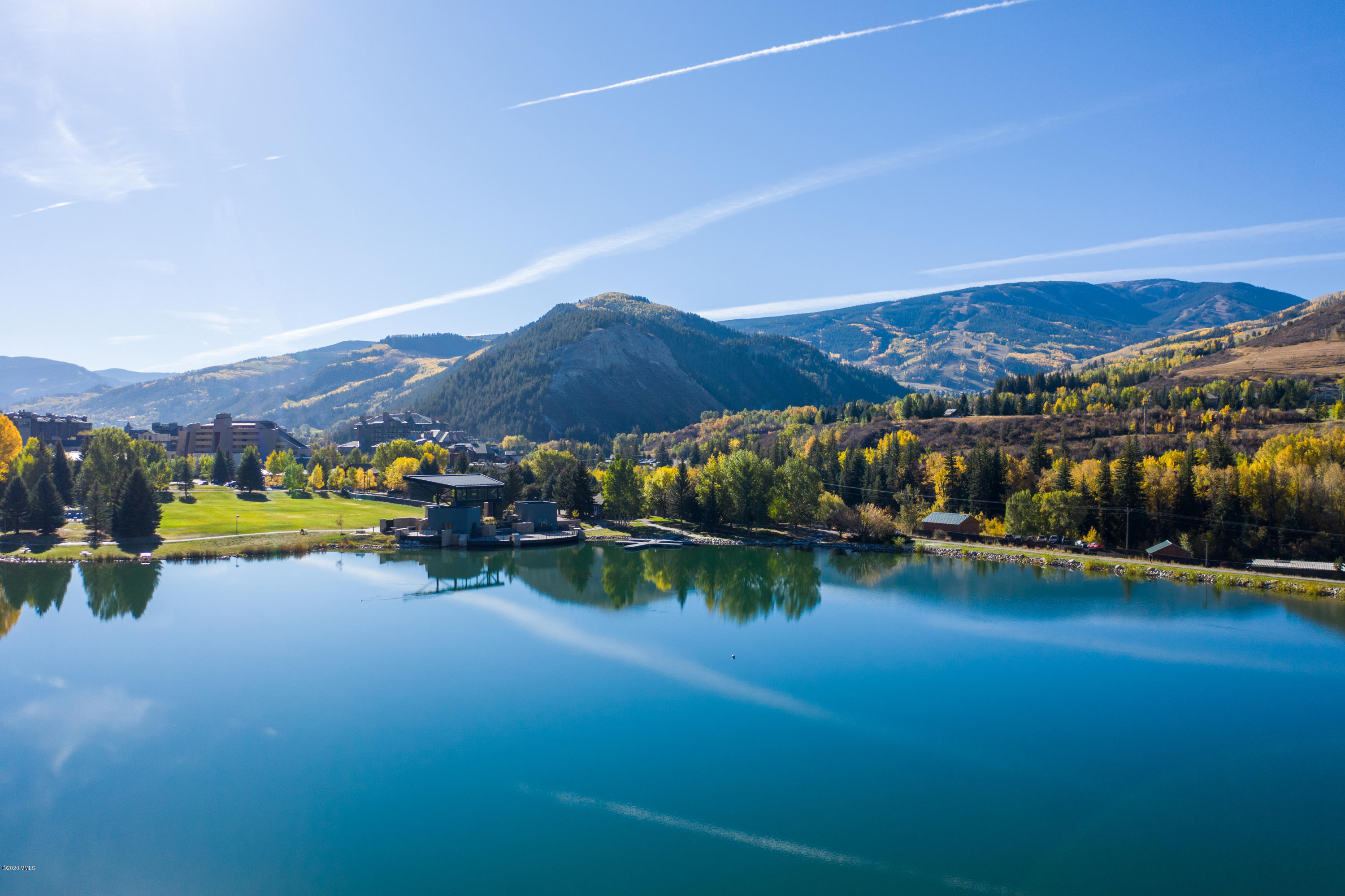 137 Benchmark Road, Unit 520 Avon, CO 81620 - Photo 21 of 22 a view of a lake with mountains in the background