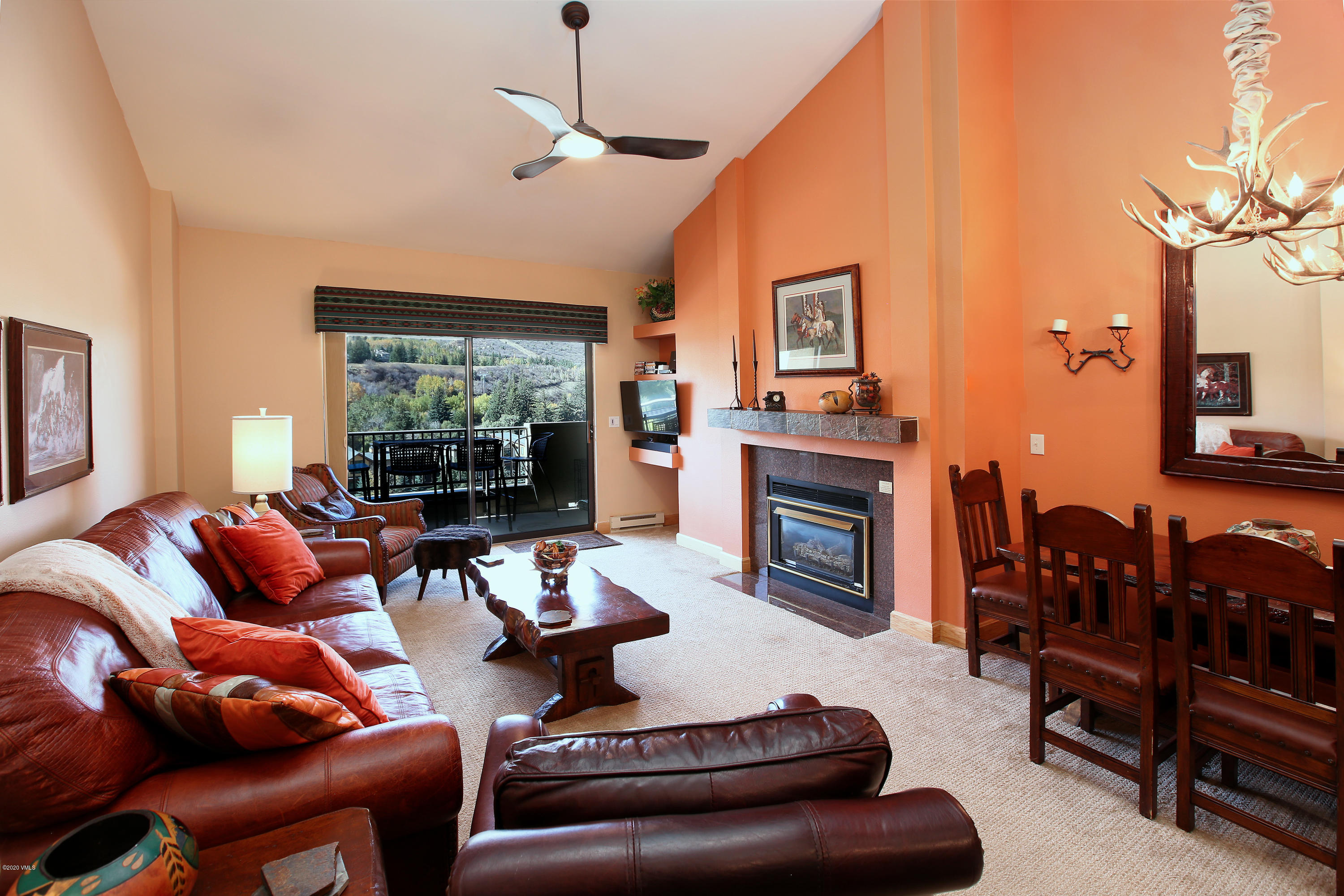 137 Benchmark Road, Unit 520 Avon, CO 81620 - Photo 7 of 22 a living room with furniture a fireplace and a large window