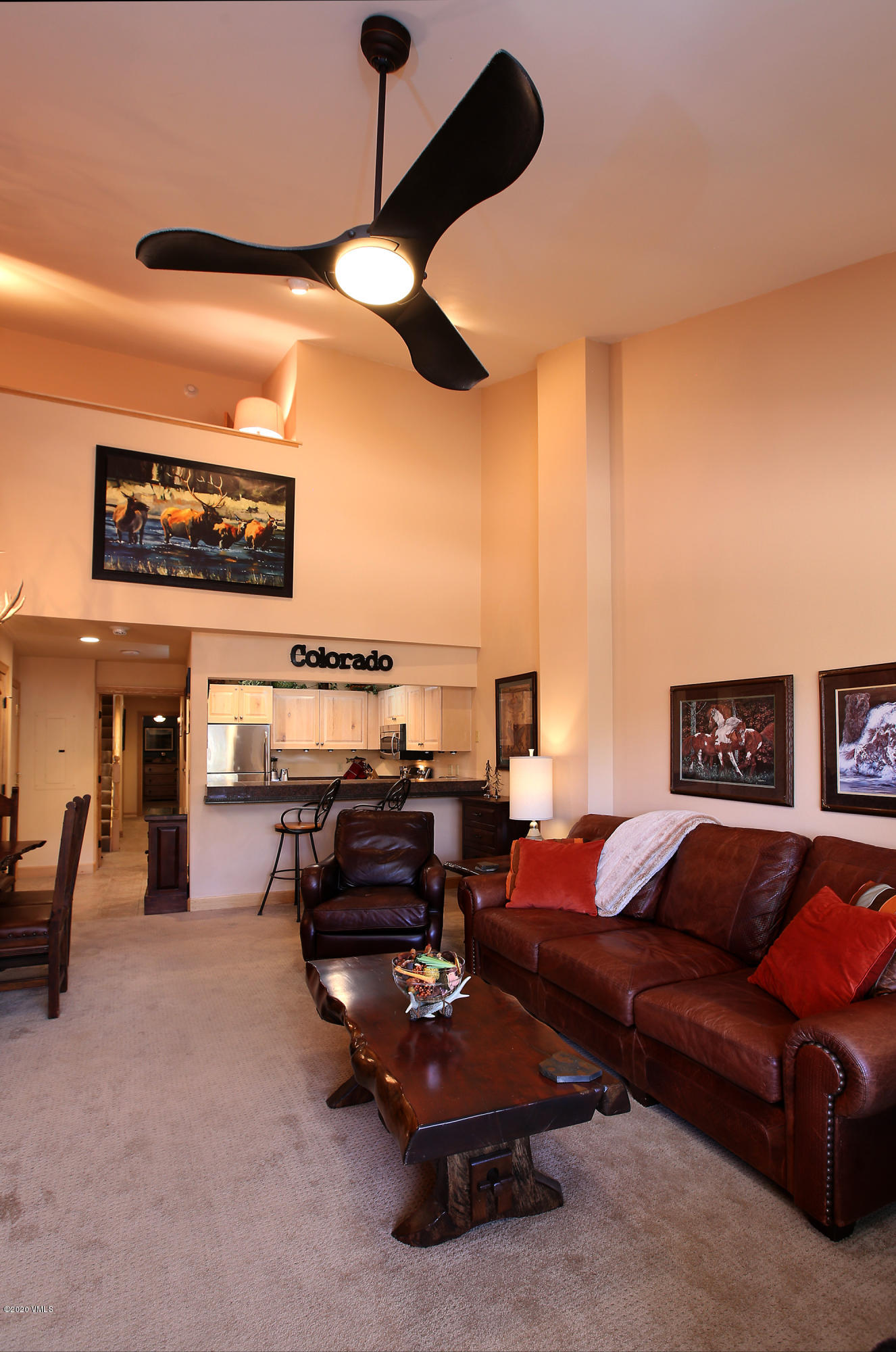 137 Benchmark Road, Unit 520 Avon, CO 81620 - Photo 8 of 22 a living room with furniture a flat screen tv and a ceiling fan