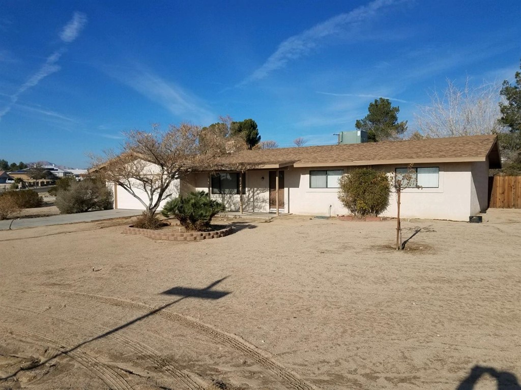 18531 Symeron Road Apple Valley, CA 92307 - Photo 1 of 1 a front view of a house with a yard