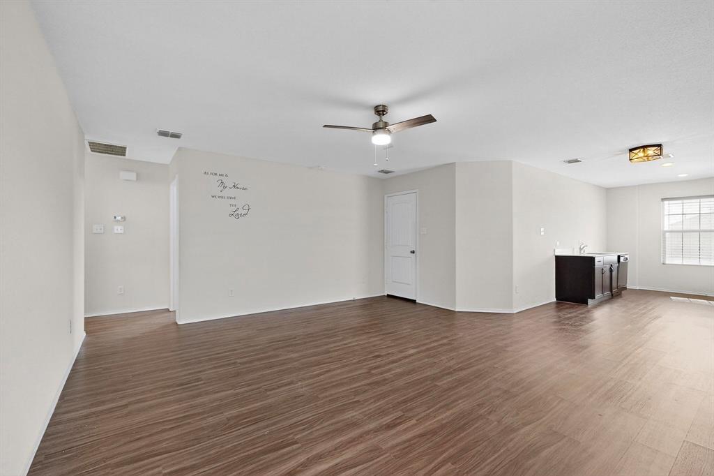 5516 McClelland Street Forney, TX 75126 - Photo 2 of 36 Unfurnished living room with dark wood-style flooring and ceiling fan