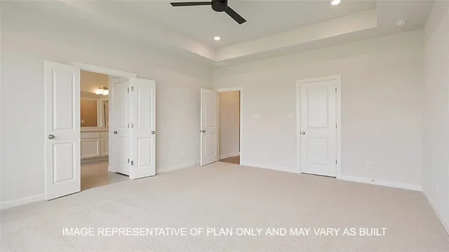 an empty room with ceiling fan and entryway