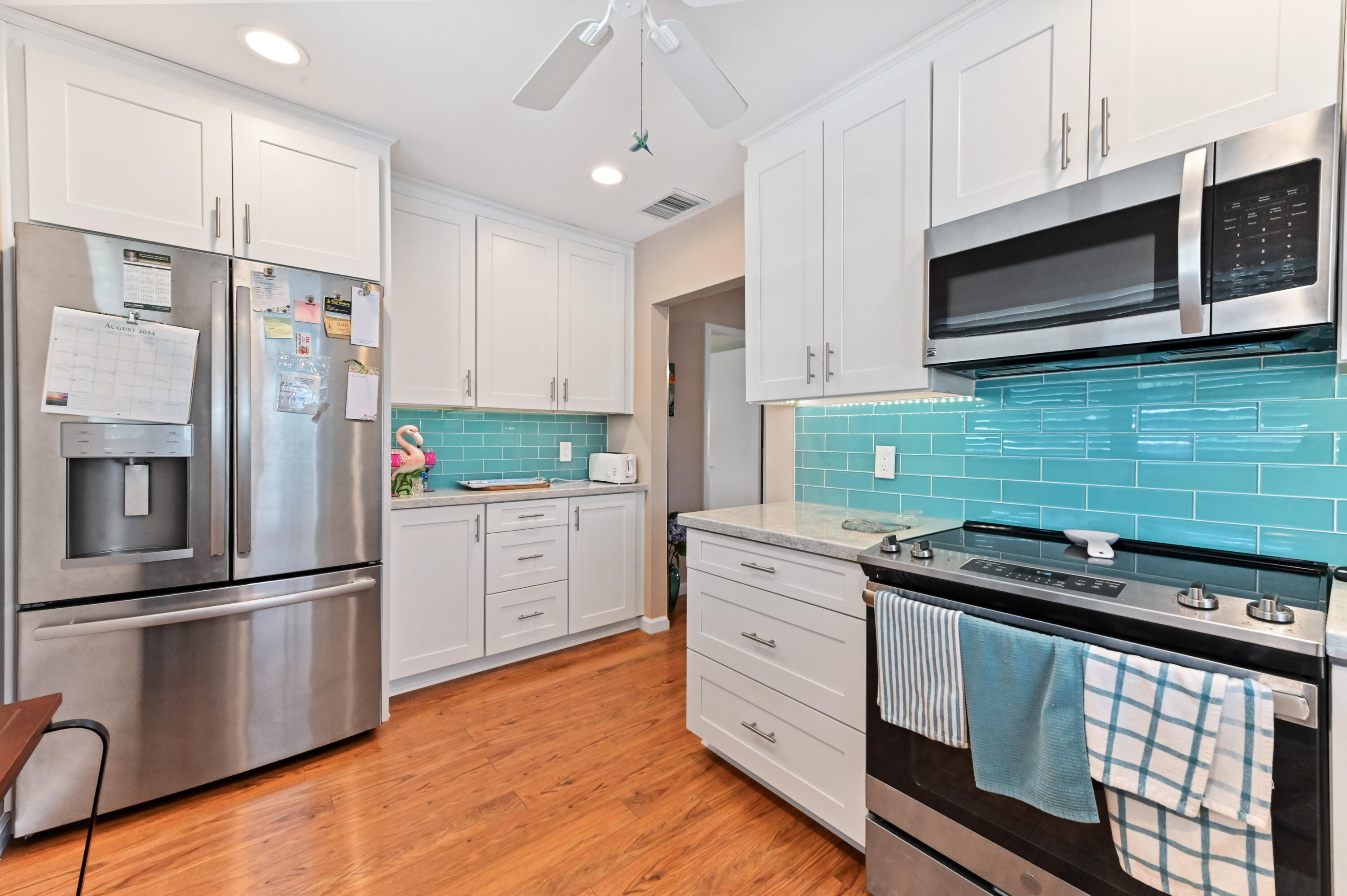 604 Hummingbird Lane Delray Beach, FL 33445 - Photo 12 of 32 a kitchen with granite countertop stainless steel appliances and cabinets