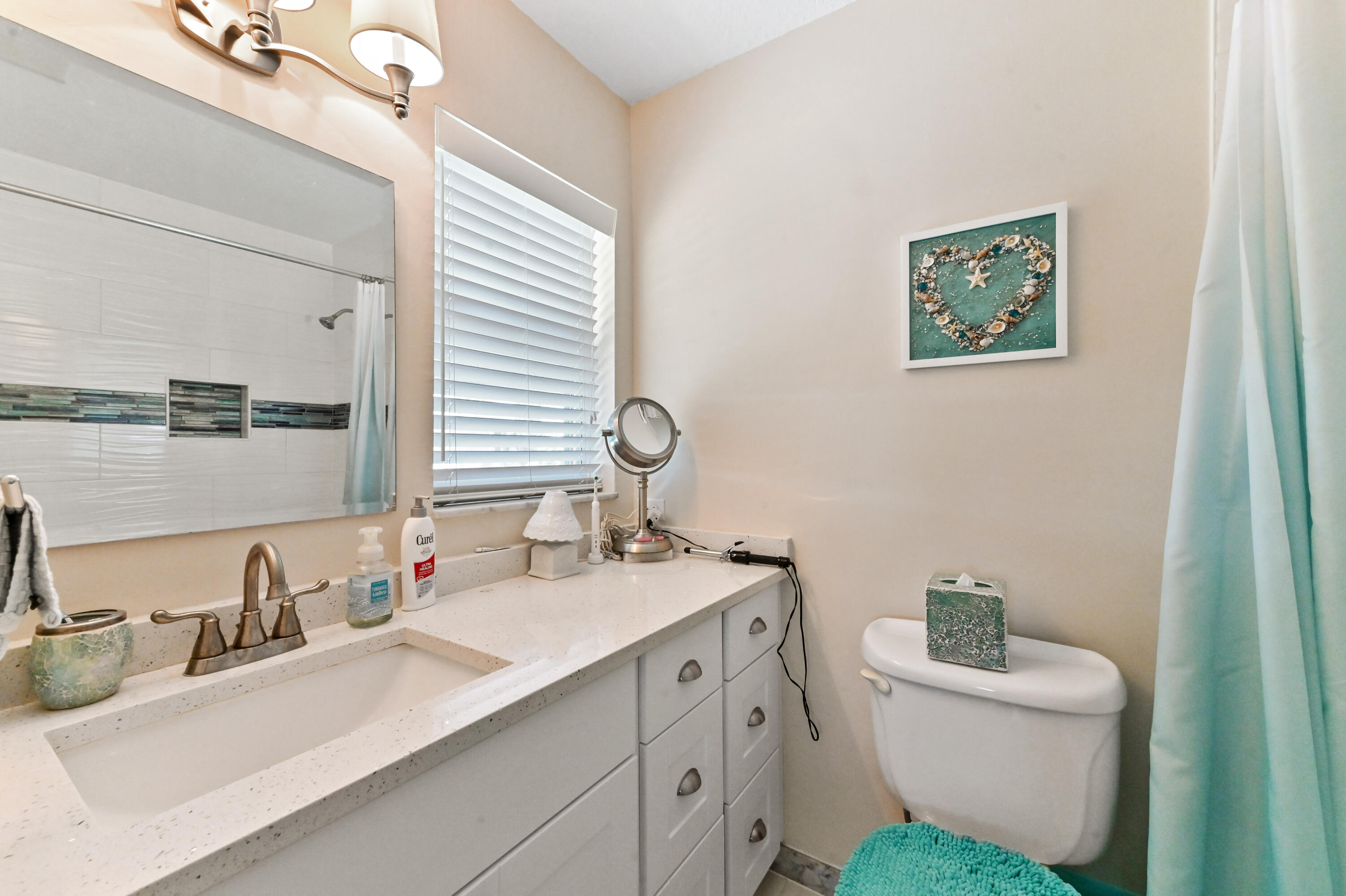 604 Hummingbird Lane Delray Beach, FL 33445 - Photo 15 of 32 a bathroom with a sink and a toilet