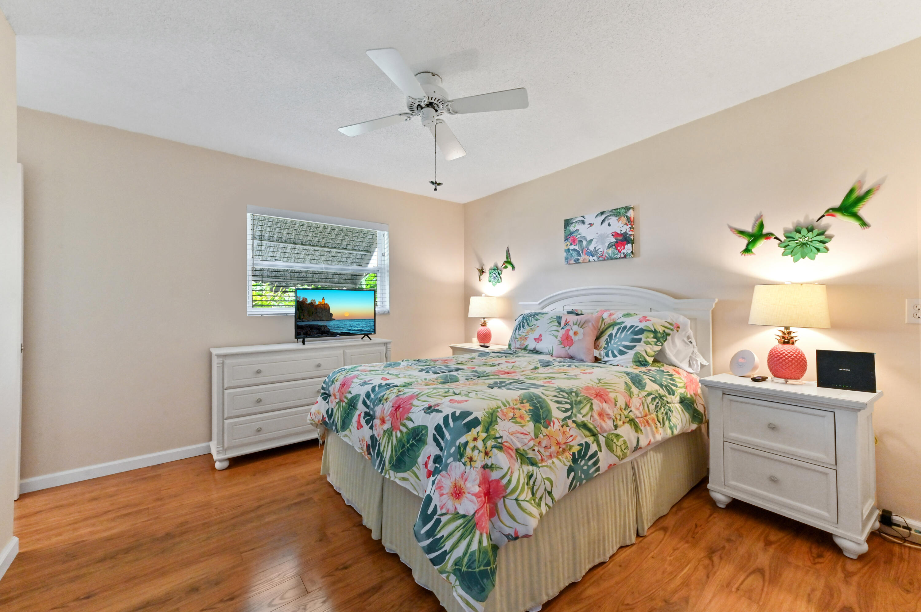 604 Hummingbird Lane Delray Beach, FL 33445 - Photo 16 of 32 a bedroom with a bed and a dresser