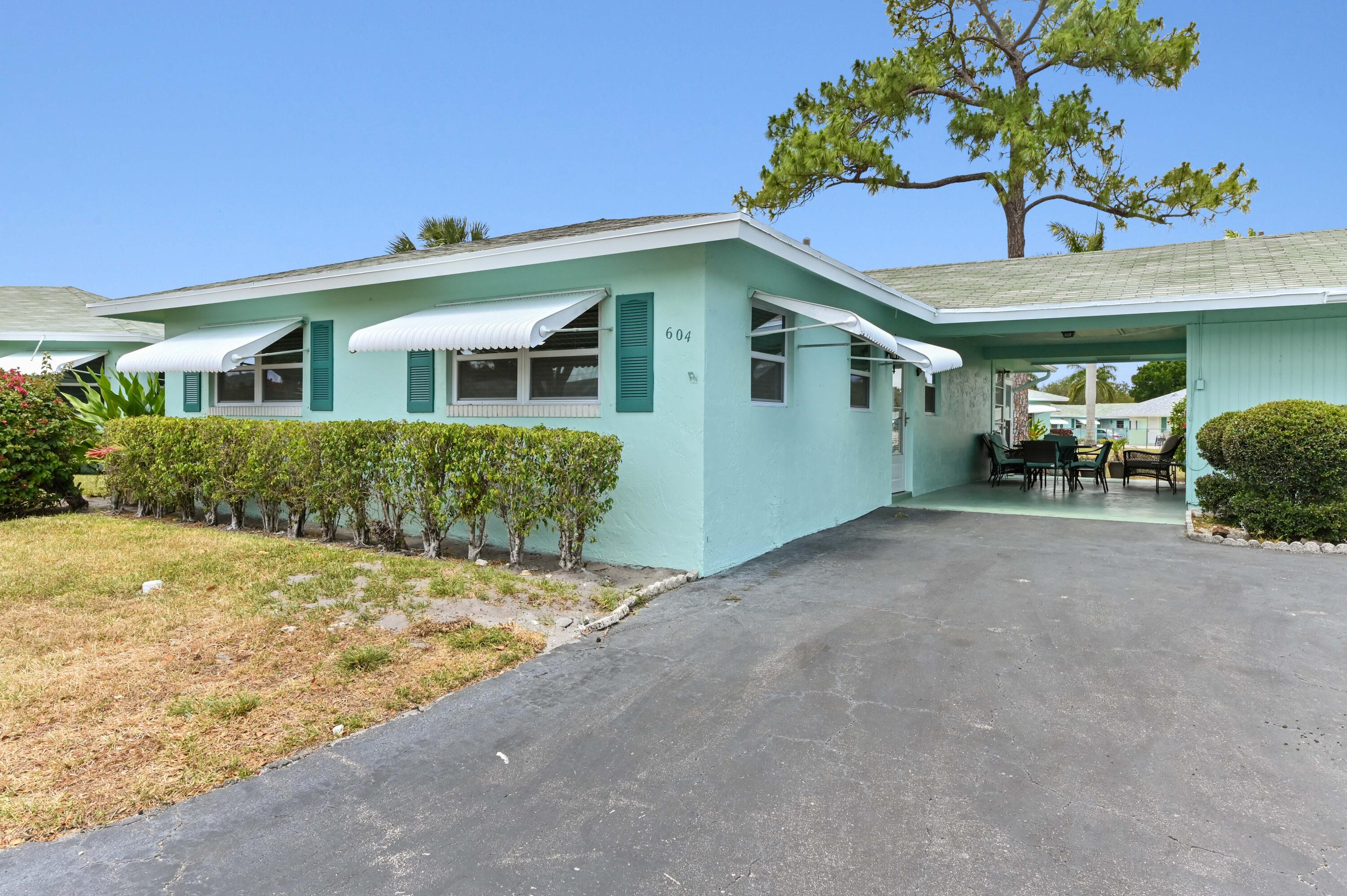 604 Hummingbird Lane Delray Beach, FL 33445 - Photo 2 of 32 a view of a house with a yard and potted plants