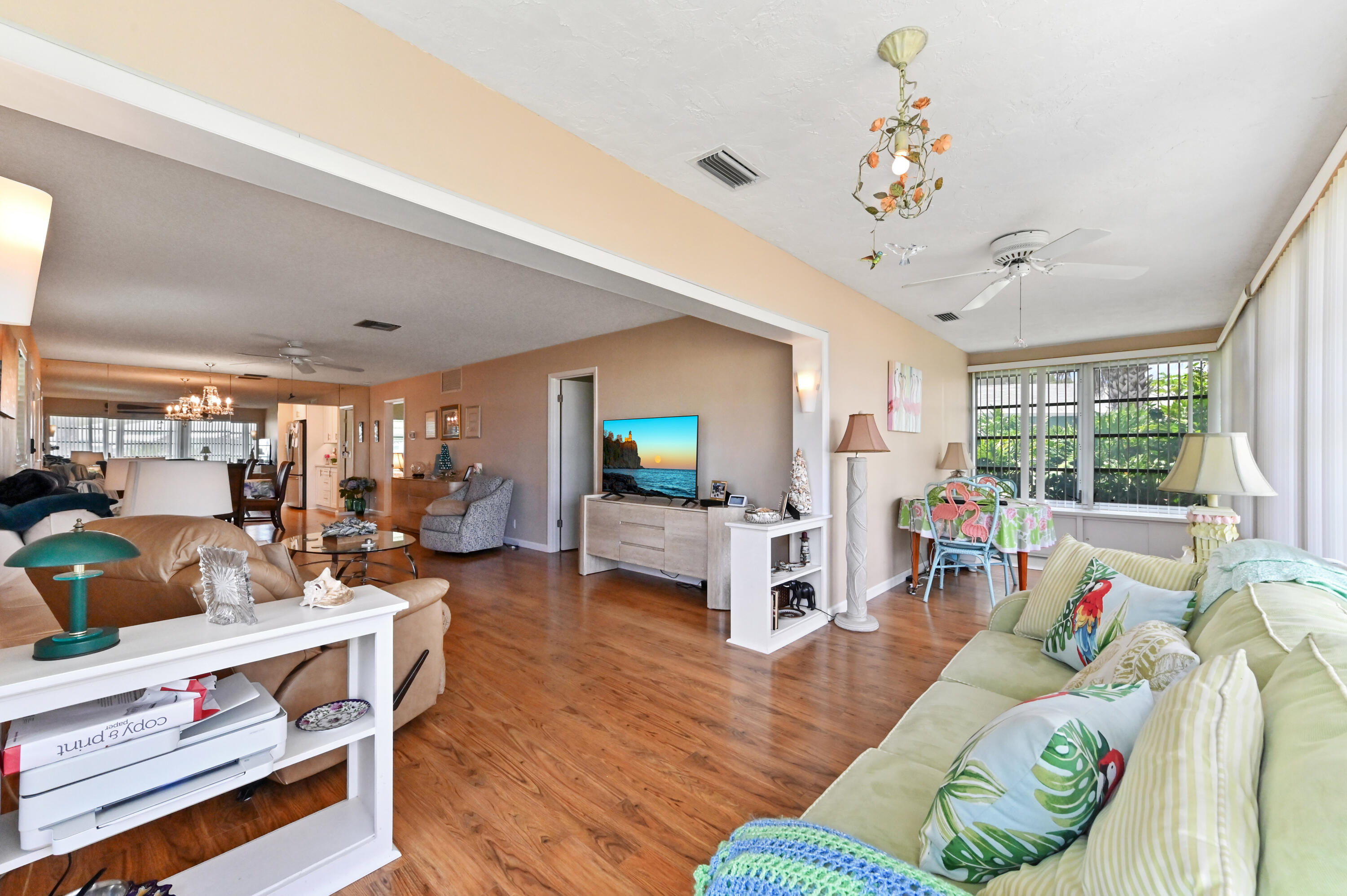 604 Hummingbird Lane Delray Beach, FL 33445 - Photo 23 of 32 a living room with furniture and a flat screen tv