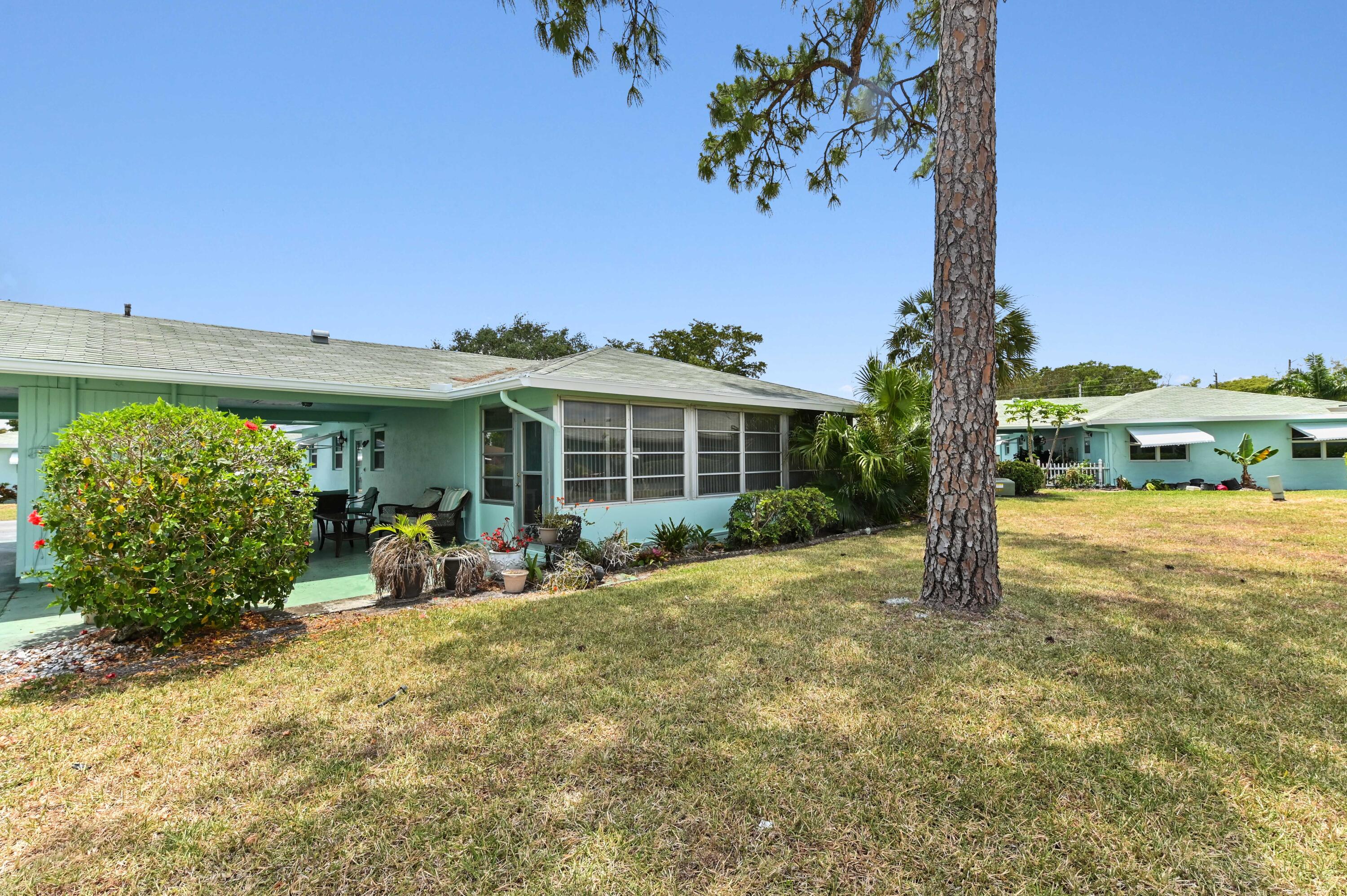 604 Hummingbird Lane Delray Beach, FL 33445 - Photo 26 of 32 a front view of a house with garden