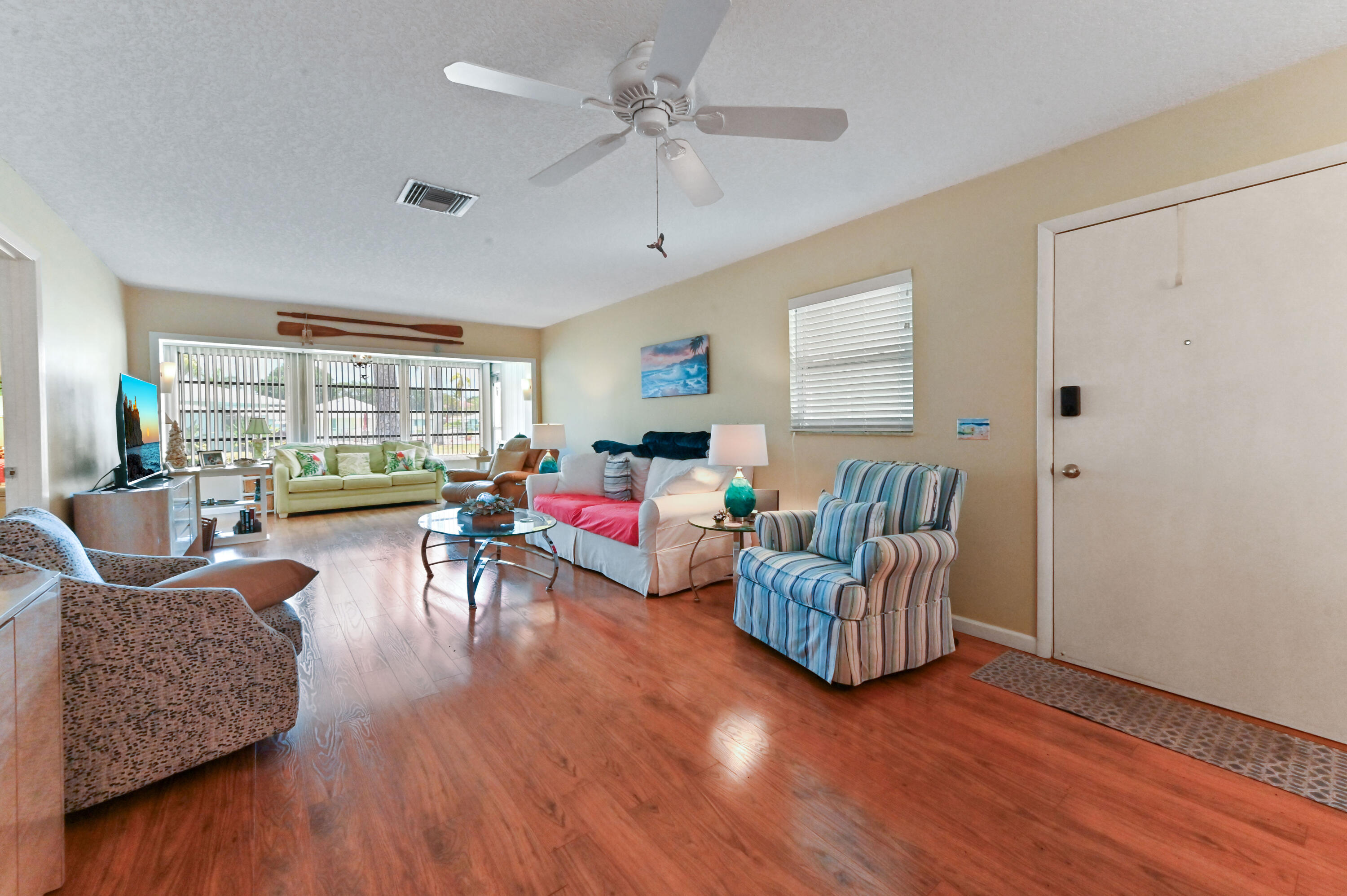 604 Hummingbird Lane Delray Beach, FL 33445 - Photo 5 of 32 a living room with furniture and a large window
