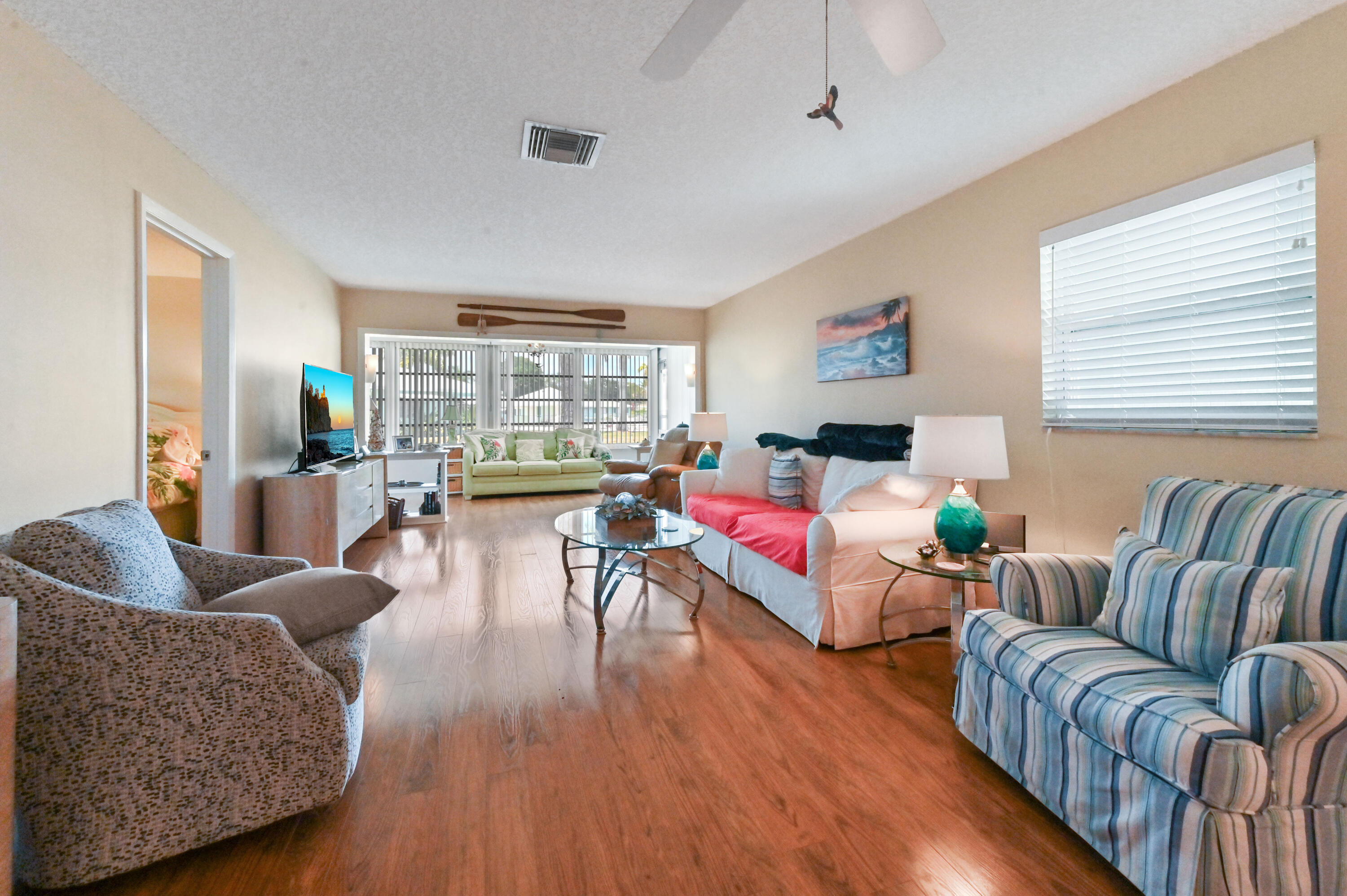 604 Hummingbird Lane Delray Beach, FL 33445 - Photo 6 of 32 a living room with furniture and a large window