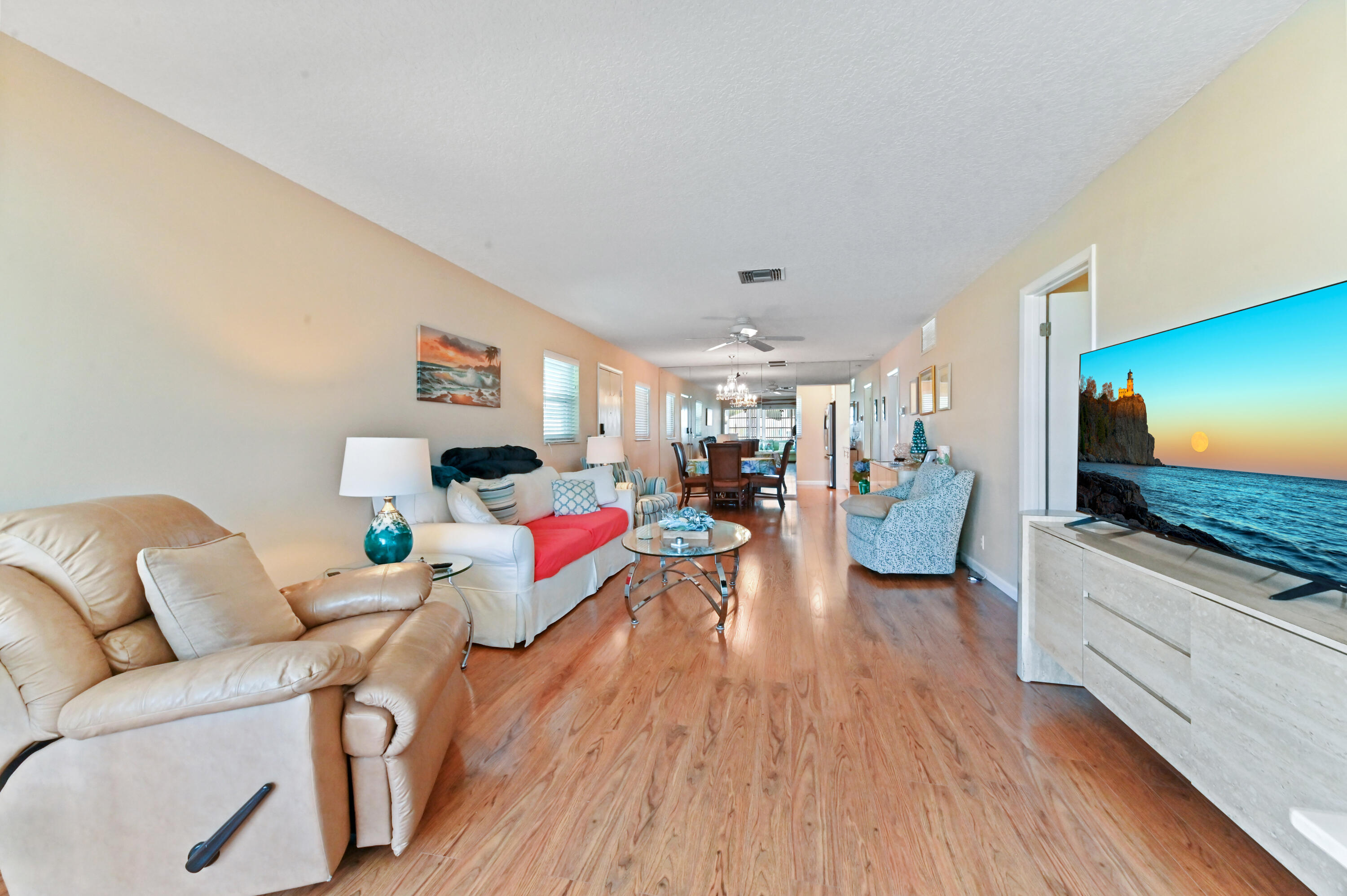 604 Hummingbird Lane Delray Beach, FL 33445 - Photo 7 of 32 a living room with furniture and a flat screen tv