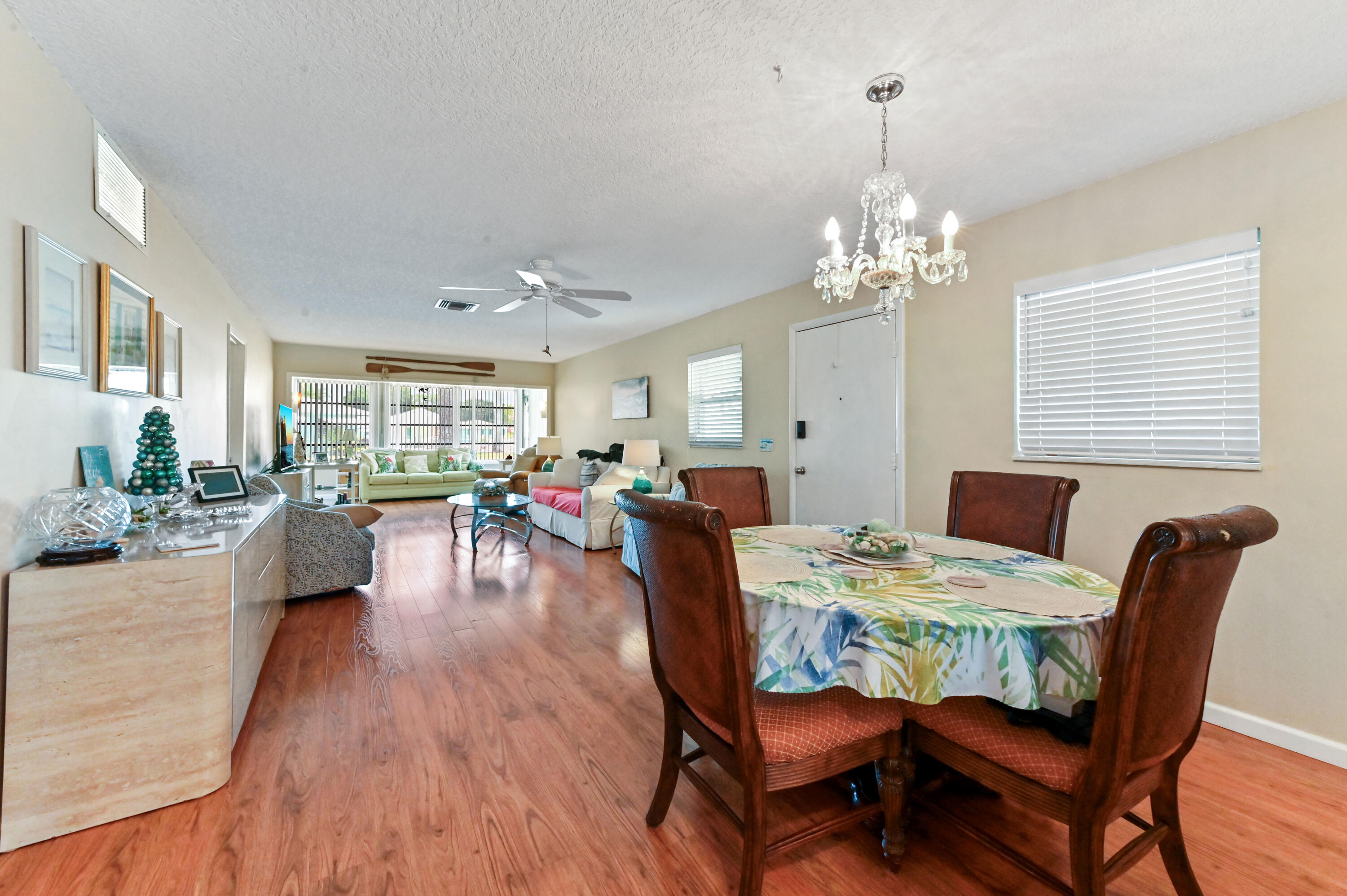 604 Hummingbird Lane Delray Beach, FL 33445 - Photo 9 of 32 a view of a dining room with furniture window and wooden floor