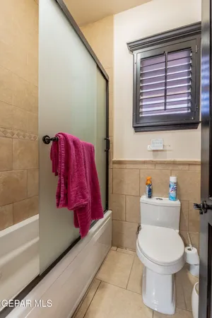 a bathroom with a granite countertop sink a mirror and a shower