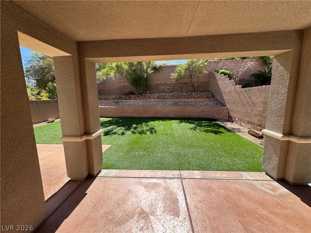 1333 Jamesbury Road Las Vegas, NV 89135 - Photo 21 of 43 A private, low-maintenance outdoor space featuring artificial turf and terraced landscaping.