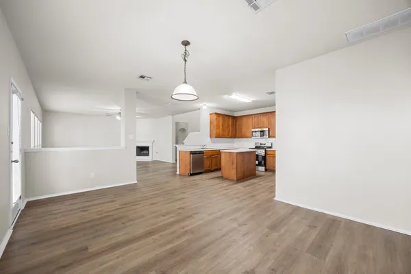 a view of a kitchen with a sink stainless steel appliances and cabinets