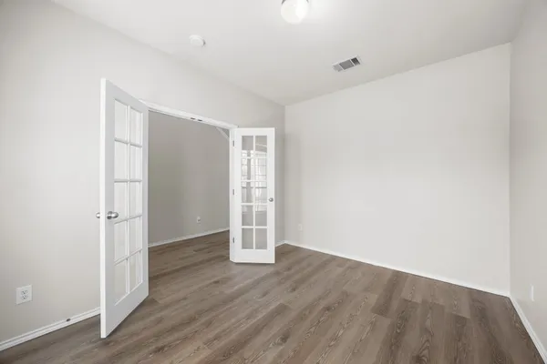 an empty room with wooden floor