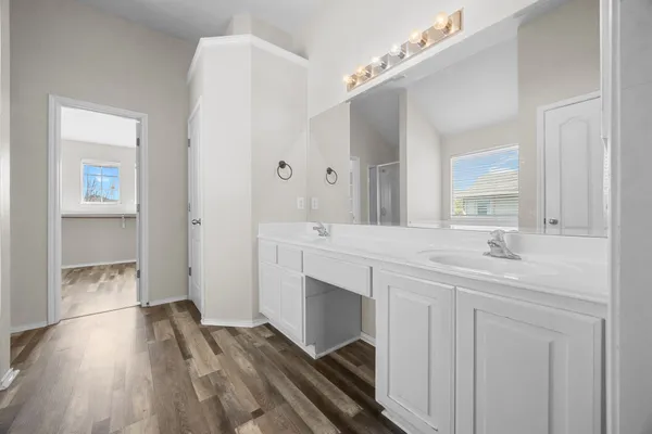 a spacious bathroom with a double vanity sink and a mirror