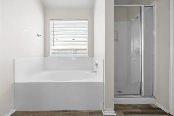 a bathroom with bathtub and shower