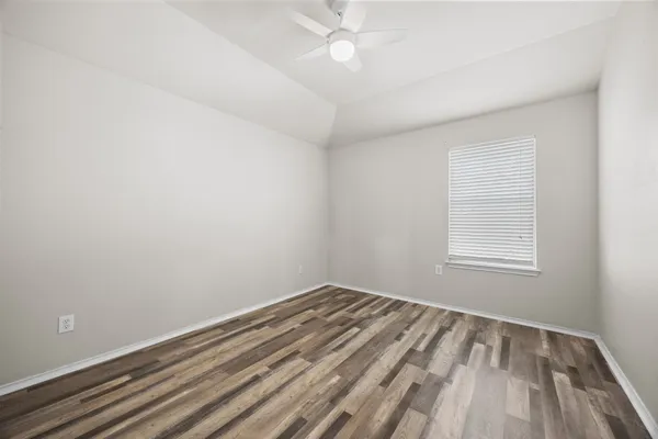 wooden floor in a room next to a window