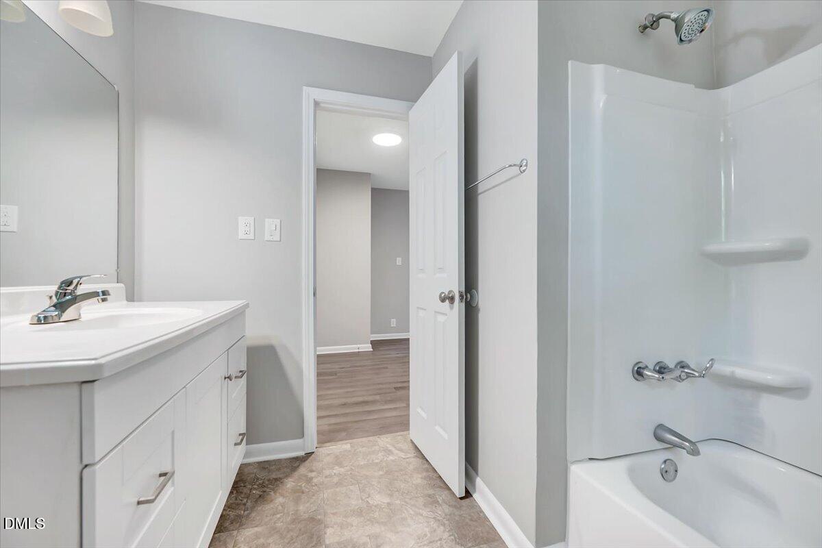 3408 Atlantic Avenue Raleigh, NC 27604 - Photo 39 of 48 a bathroom with a tub sink and mirror