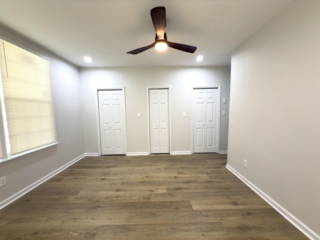 4103 Orleans Road Memphis, TN 38116 - Photo 8 of 32 a view of an empty room with window and wooden floor