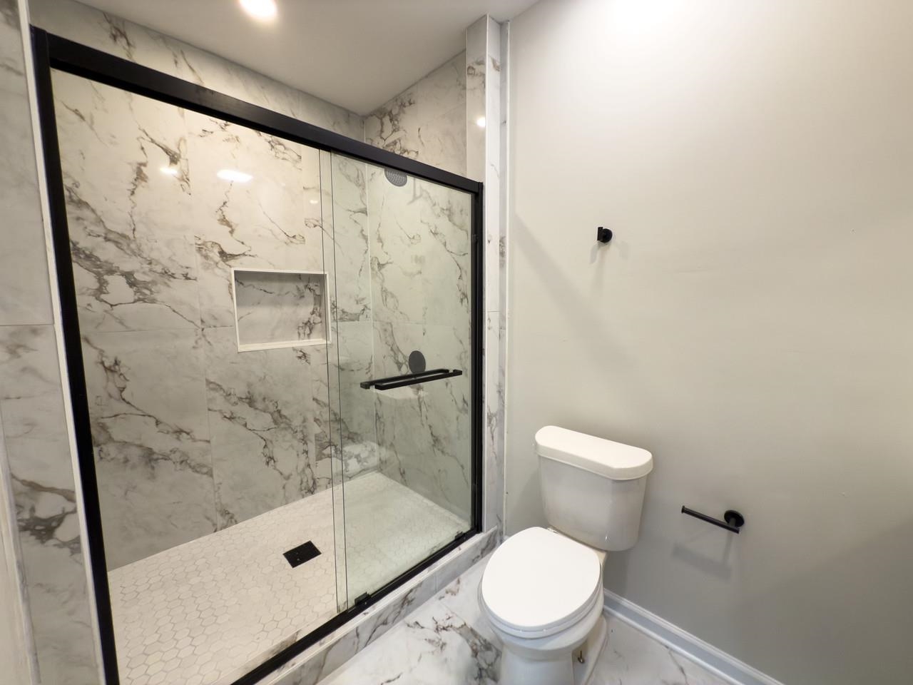 4103 Orleans Road Memphis, TN 38116 - Photo 13 of 32 a bathroom with a shower and toilet