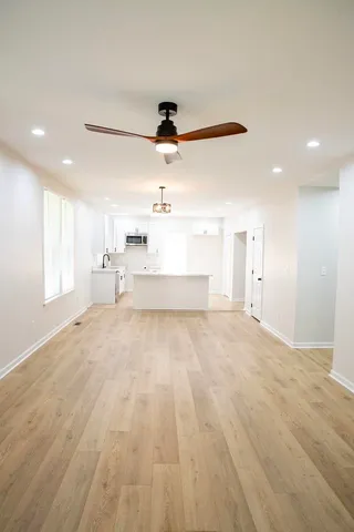 a view of a kitchen with a sink and cabinets