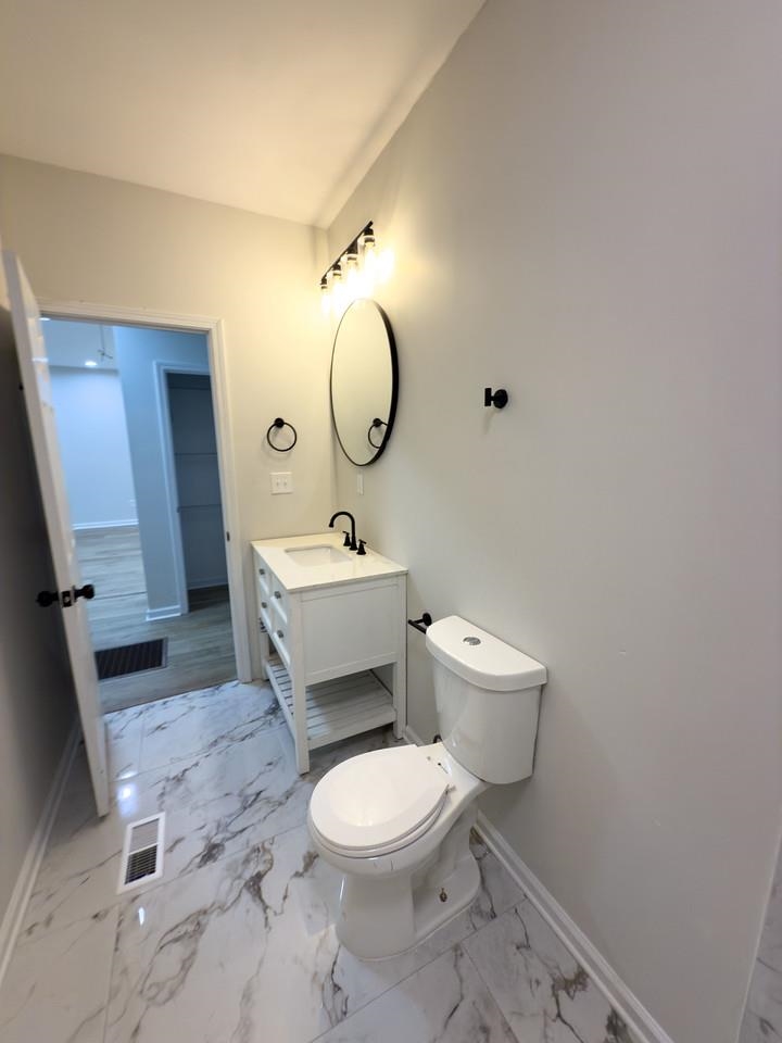 4103 Orleans Road Memphis, TN 38116 - Photo 21 of 32 a bathroom with a toilet a sink and mirror
