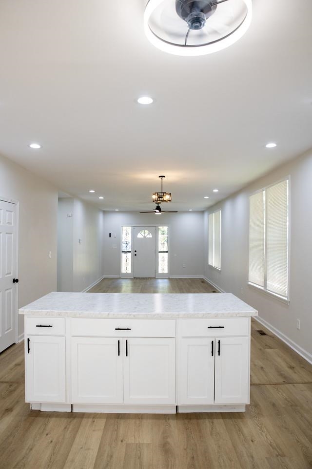 4103 Orleans Road Memphis, TN 38116 - Photo 30 of 32 a large white kitchen with granite countertop a white cabinets and a fireplace