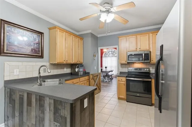 a kitchen with stainless steel appliances a stove refrigerator and microwave
